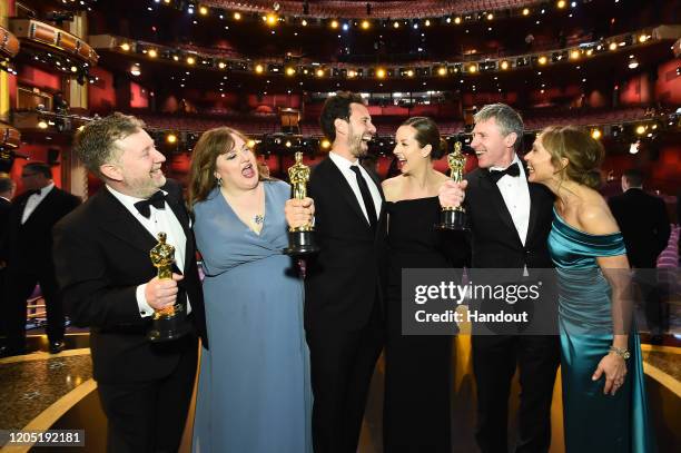 In this handout photo provided by A.M.P.A.S. Visual Effects award winners Greg Butler, Guillaume Rocheron, and Dominic Tuohy pose onstage during the...