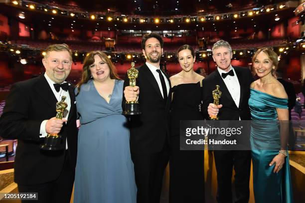 In this handout photo provided by A.M.P.A.S. Visual Effects award winners Greg Butler, Guillaume Rocheron, and Dominic Tuohy pose onstage during the...