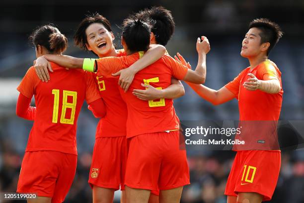 The China players celebrate with Wu Haiyan of China after she scored at goal during the Women's Olympic Football Tournament Qualifier match between...