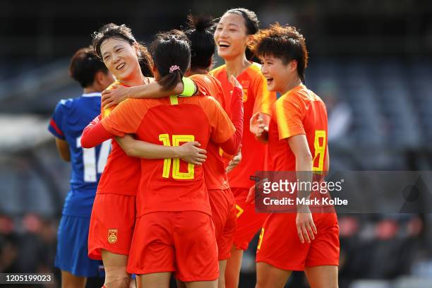 The China players celebrate with Wu Haiyan of China after she scored at goal during the Women's Olympic Football Tournament Qualifier match between...