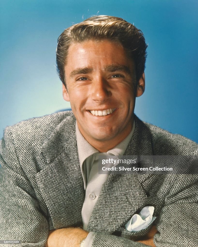 Peter Lawford , British-US actor, wearing a grey jacket and smiling ...