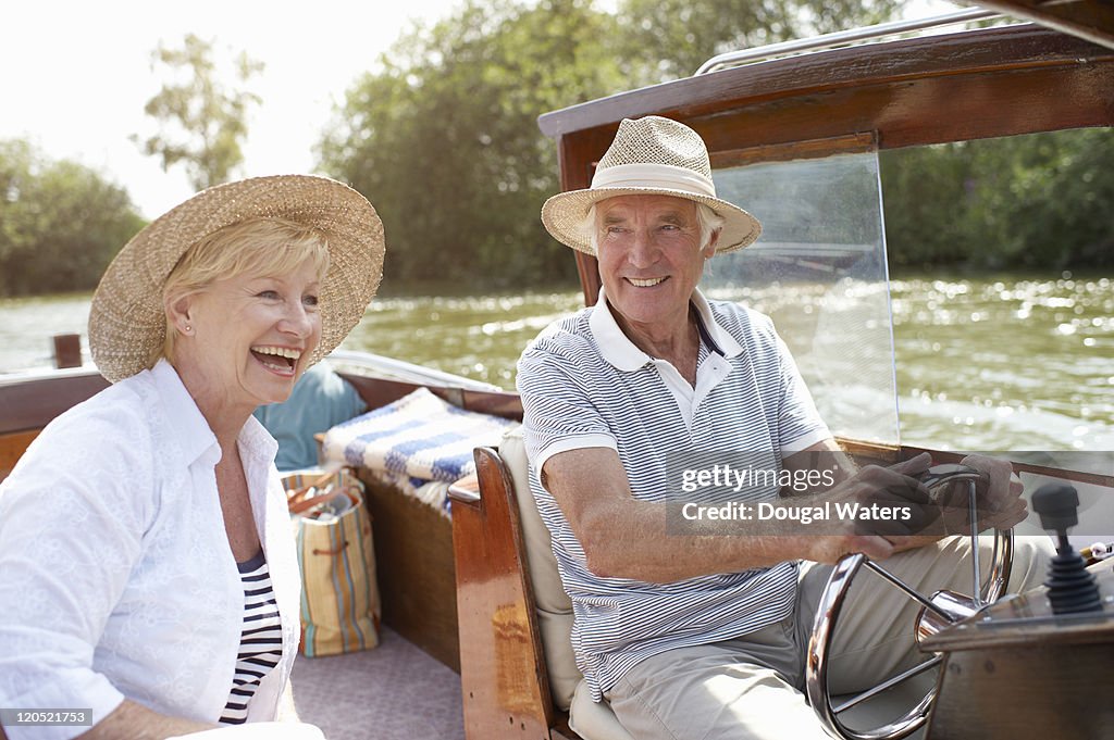 Couple laughing together in boat.