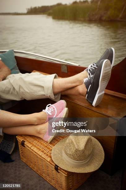 feet of couple relaxing in boat. - punting foto e immagini stock