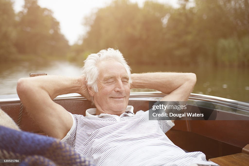 Senior man relaxing on boat.