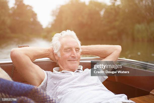 senior man relaxing on boat. - boat old stock pictures, royalty-free photos & images