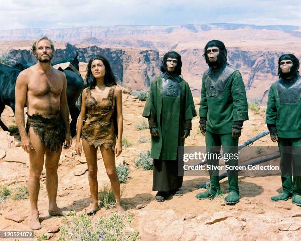 Charlton Heston , US actor, and Linda Harrison, US actress, both wearing animal hides, alongside Kim Hunter , Roddy McDowall and Lou Wagner, all...