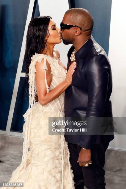 Kim Kardashian West and Kanye West kiss at the 2020 Vanity Fair Oscar Party at Wallis Annenberg Center for the Performing Arts on February 09, 2020...