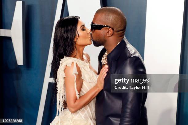 Kim Kardashian West and Kanye West kiss at the 2020 Vanity Fair Oscar Party at Wallis Annenberg Center for the Performing Arts on February 09, 2020...