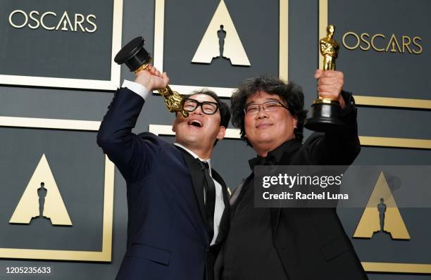 Han Jin-won and Bong Joon-ho, winners of the Original Screenplay award for "Parasite," pose in the press room during the 92nd Annual Academy Awards...