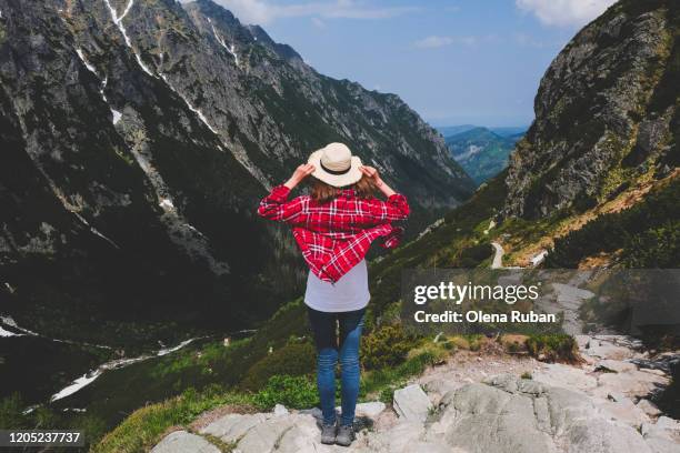 young woman in plaid shirt looks in mountains - tatra mountains stock pictures, royalty-free photos & images