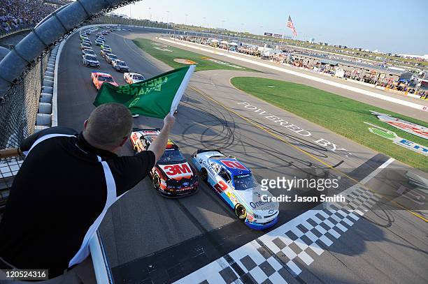 Elliott Sadler, driver of the OneMain Financial Chevrolet, and Trevor Bayne, driver of the 3M Ford, lead the field to the green flag to start the...