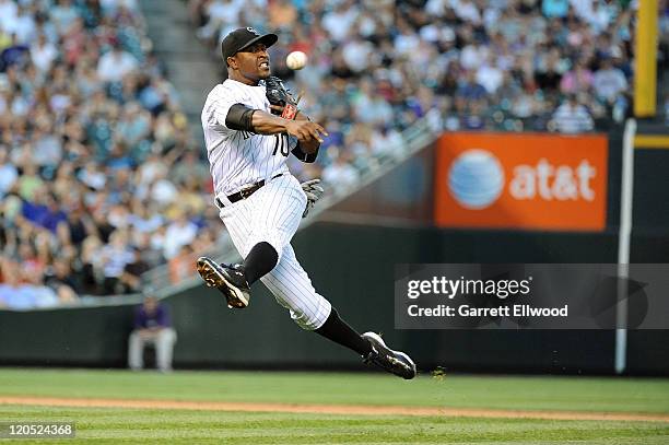 Chris Nelson of the Colorado Rockies throws to first base during the game against the Washington Nationals at Coors Field on August 6, 2011 in...