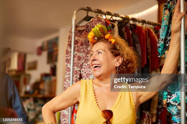 a fun senior woman poses with an exotic diadem. - eccentric woman stock pictures, royalty-free photos & images
