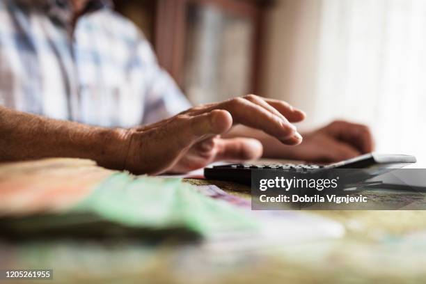 disabled man calculating with the money - pension money stock pictures, royalty-free photos & images