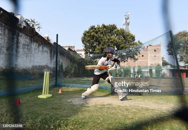 Girl plays a shot during a practice session at a cricket academy, on February 29, 2020 in Agra, India. Agra has produced so many women cricketers...