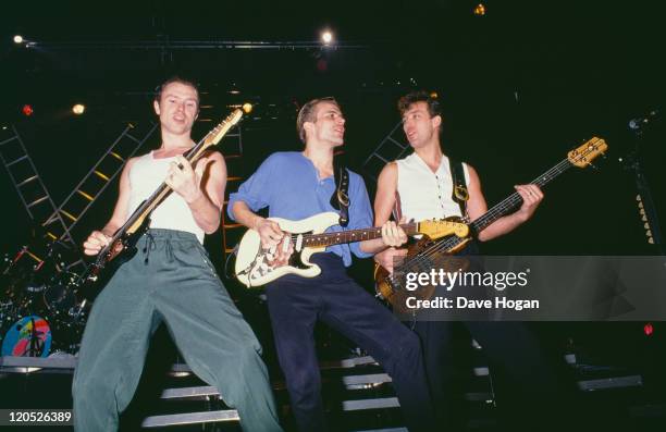 Gary Kemp, Steve Norman and Martin Kemp, of British pop group Spandau Ballet, performing on stage, circa 1985.
