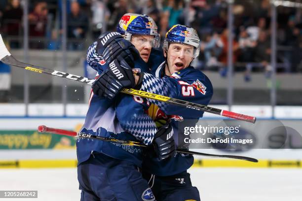 Philip Gogulla of EHC Red Bull Muenchen celebrates after scoring his team's third goal with teammates during the DEL match between EHC Red Bull...