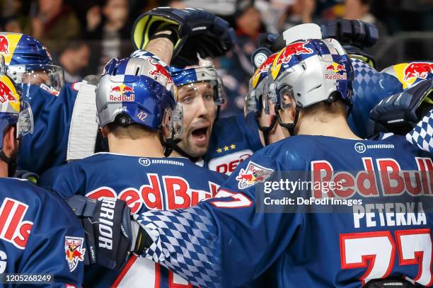 Philip Gogulla of EHC Red Bull Muenchen celebrates after scoring his team's third goal with teammates during the DEL match between EHC Red Bull...