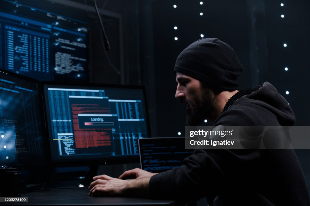 Computer Hacker Coding On Keyboard On A Background Of Monitors High-Res ...