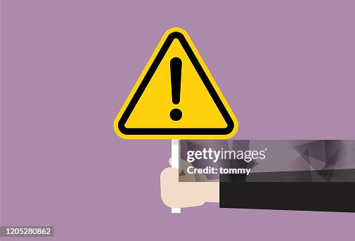 The human hand holds a exclamation sign The human hand holds a exclamation sign