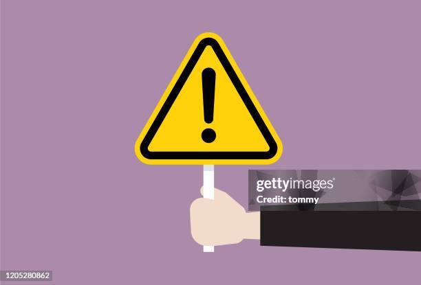 the human hand holds a exclamation sign - hazard stock illustrations