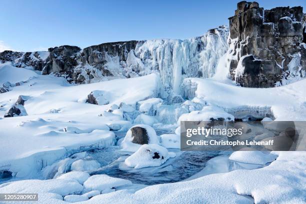 oxararfoss waterfall in iceland, during winter. - frozen waterfall stockfoto's en -beelden