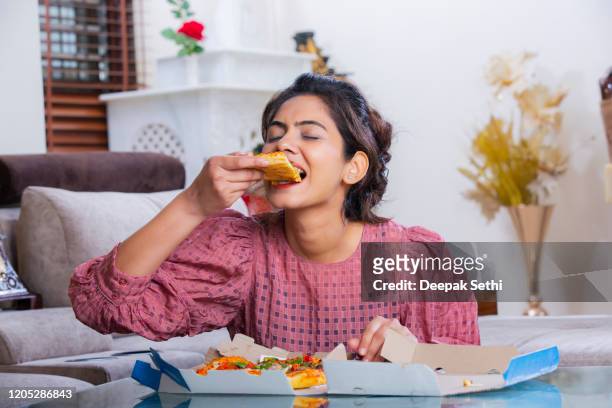 eating pizza stock photo - enjoyment stock pictures, royalty-free photos & images