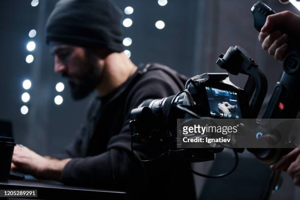 backstage shooting a movie about hackers on a movie camera. - behind the scenes stock pictures, royalty-free photos & images
