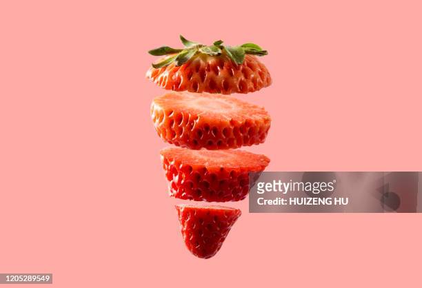 sliced strawberry on pink background. fresh cut strawberry. - wedge stockfoto's en -beelden