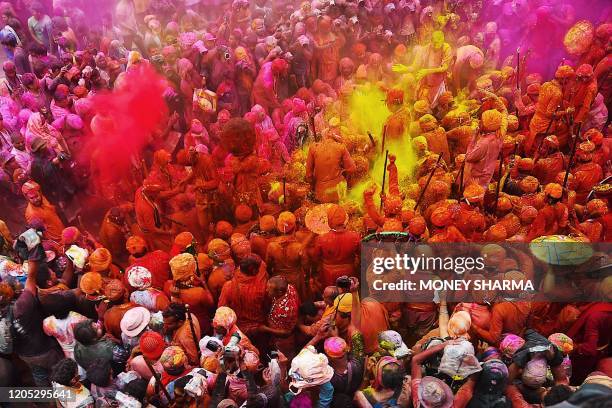 Hindu devotees celebrate Holi, the spring festival of colours, during a traditional gathering at a temple in Nandgaon village in Uttar Pradesh state...