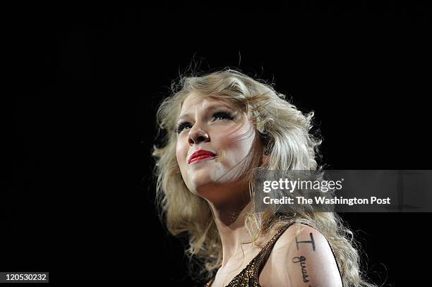 Country pop star Taylor Swift takes a moment to listen to her cheering of her fans while performing at the Verizon Center. Swift, who is 21, appeared...