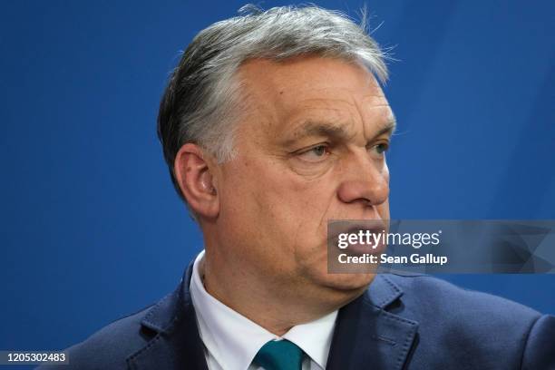 Hungarian Prime Minister Viktor Orban and German Chancellor Angela Merkel speak to the media prior to talks at the Chancellery on February 10, 2020...