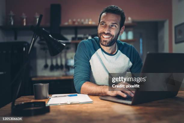 man working at home late at night - author laptop stock pictures, royalty-free photos & images