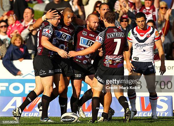 William Hopoate of the Sea Eagles is congratulated after scorign a try during the round 22 NRL match between the Manly Warringah Sea Eagles and the...
