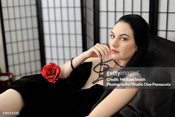 beautiful young adult female with long black hair - perla negra fotografías e imágenes de stock