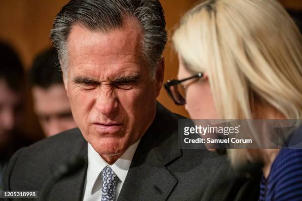 Sen. Mitt Romney and Sen. Kyrsten Sinema speak to each other during a Senate Homeland Security Committee hearing on the government's response to the...
