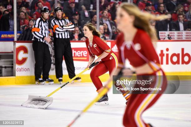 Calgary Flames ice girls clean the ice during the second period of an NHL game where the Calgary Flames hosted the Columbus Blue Jackets on March 4...
