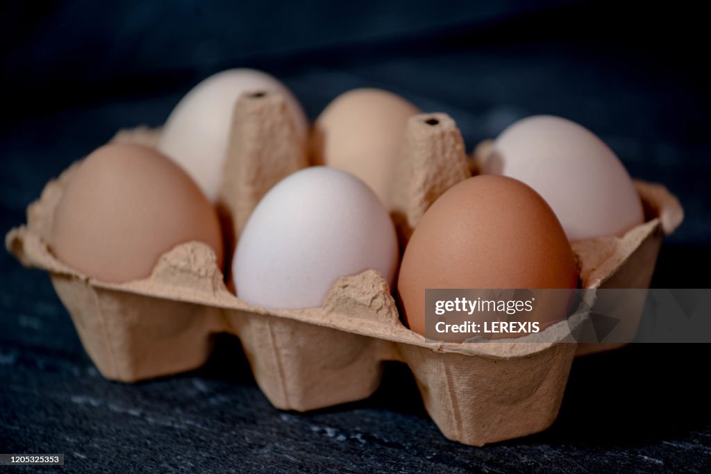 Cardboard package with eggs on a black background