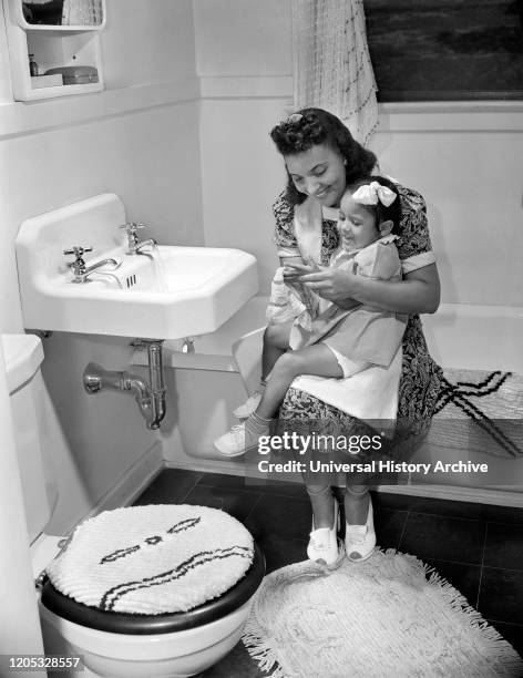 Mother and Daughter in Bathroom, Frederick Douglass Housing Project, Anacostia Neighborhood, Washington DC, USA, Photograph by Gordon Parks, July...