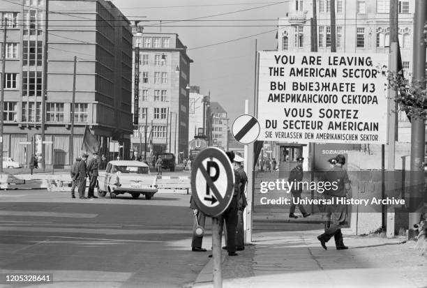 Checkpoint in West Berlin, West Germany with sign "You are leaving the American Sector" in four languages, photograph by Thomas J. O'Halloran,...