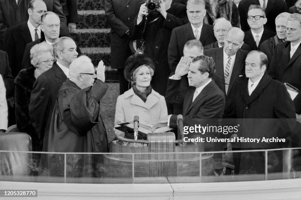 Chief Justice Earl Warren administering the oath of office to Richard M. Nixon on the east portico of the U.S. Capitol, Washington DC, USA,...