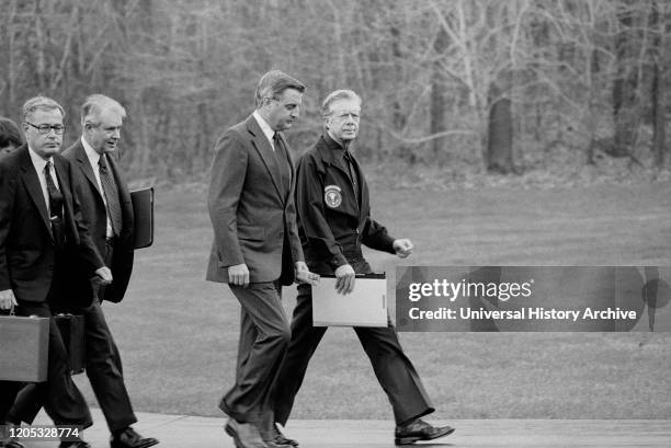 President Jimmy Carter, Vice President Walter Mondale, Secretary of State Cyrus Vance, and Secretary of Defense Harold Brown after disembarking from...