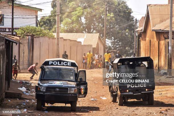 Protesters hurl stones to riot police during an unauthorised demonstration called by the political opposition to the President in Conakry on March 5,...