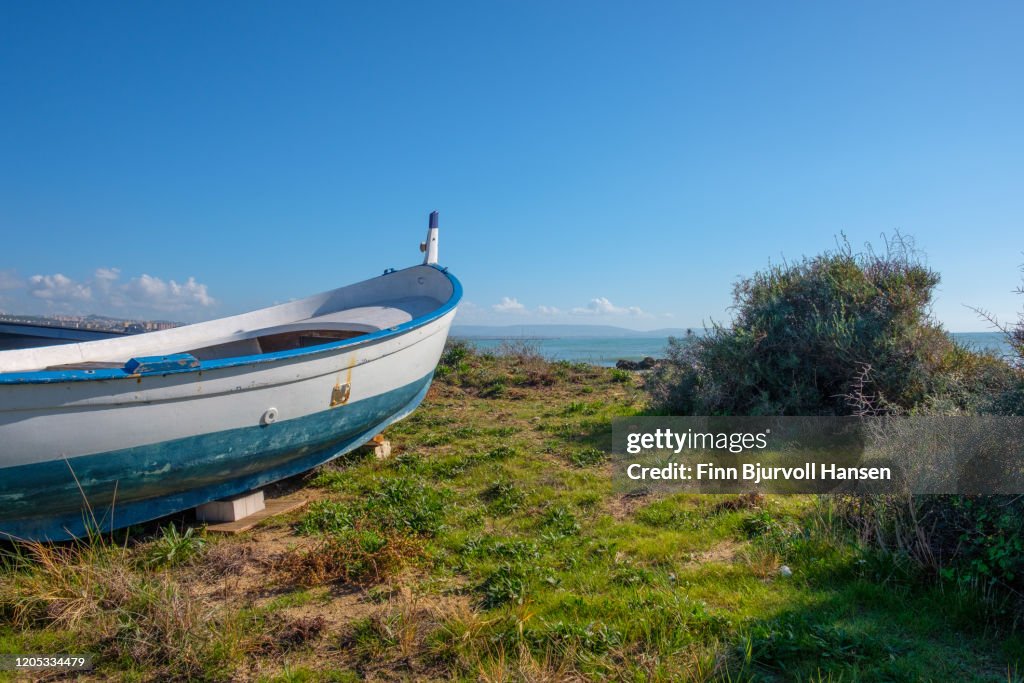 White boat standing on land