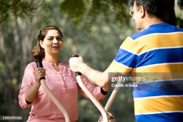 couple exercising in open air gym - open workouts stock pictures, royalty-free photos & images