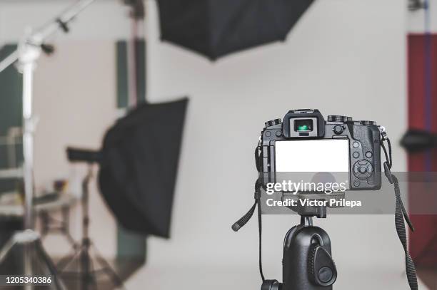 mock up of a professional camera, in a photo studio, against the background of softbox light sources. - photo shoot imagens e fotografias de stock