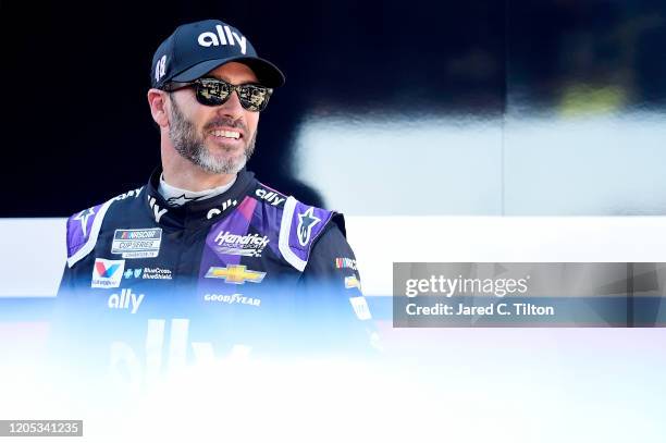 Jimmie Johnson, driver of the Ally Chevrolet, stands in the garage area during practice for the NASCAR Cup Series 62nd Annual Daytona 500 at Daytona...