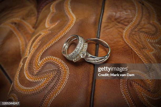 diamond wedding rings on leather cowboy boots - cowboy boot macro stock pictures, royalty-free photos & images