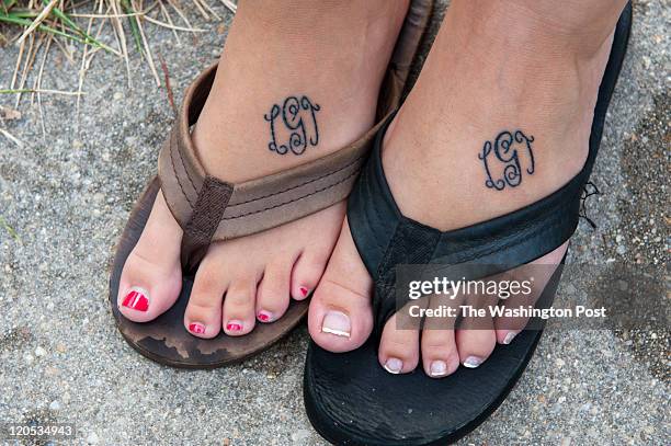 Sarah Giddings and Kaitlyn Wheeler had their feet tattooed with their sister Lauren's initials after learning of their sister's death in Laurel,...