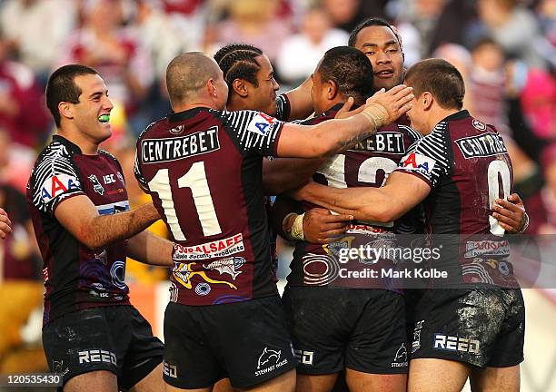 Tony Williams of the Sea Eagles is congratulated by his team mates after scoring a try during the round 22 NRL match between the Manly Warringah Sea...